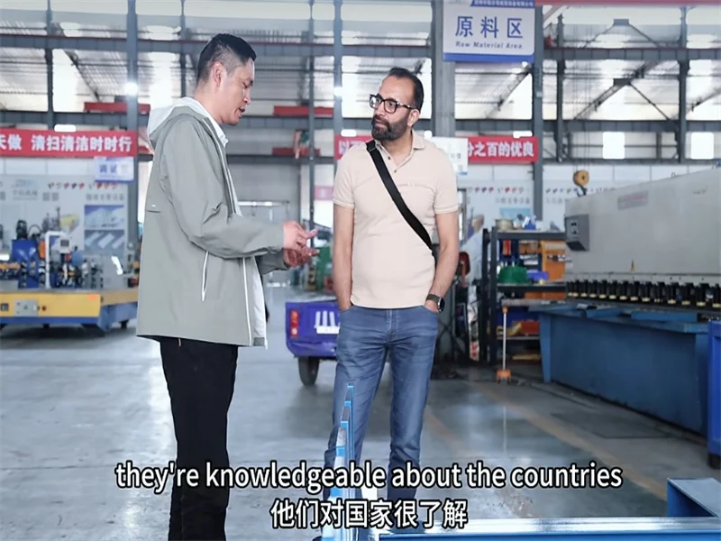 Good News Canadian Customers Praise Automatic Trough Cable Tray Roll Forming Machine 2 Canadian customers discussing technical details of cable tray production line with ZTRFM engineers in factory
